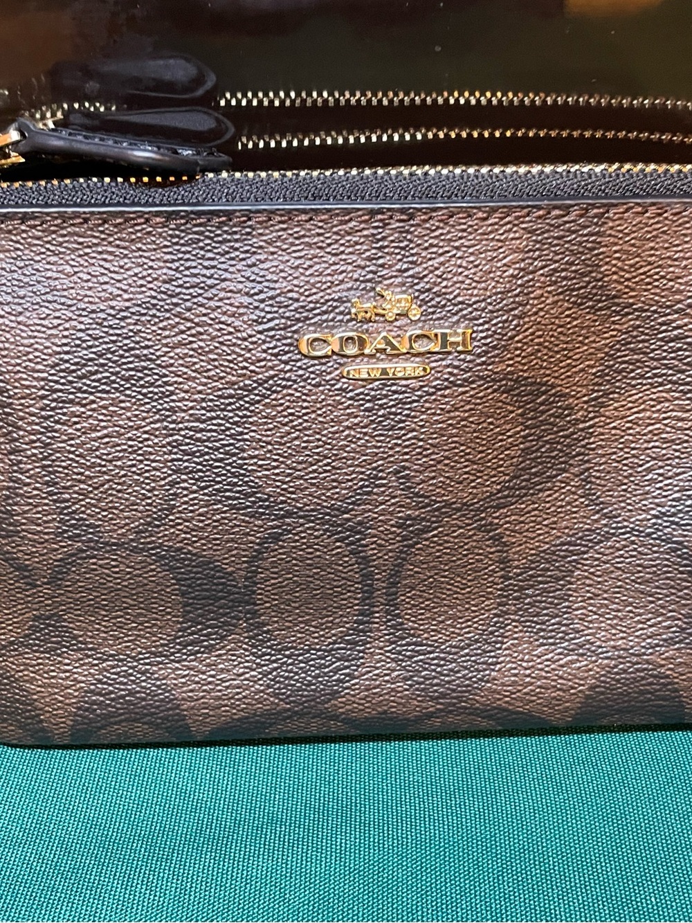 Beautiful COACH brown signature monogram double zip wristlet with strap.